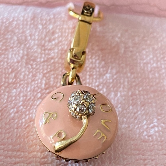 Juicy Couture Jewelry - NWT and Box Juicy Couture cup cake in pink with gold tone accents. Always in box